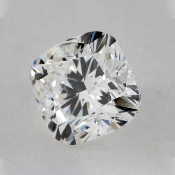 a cushion cut diamond on a white surface