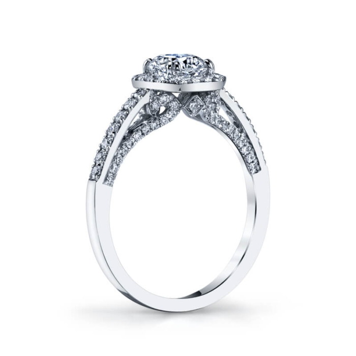 a white gold engagement ring with an oval diamond center