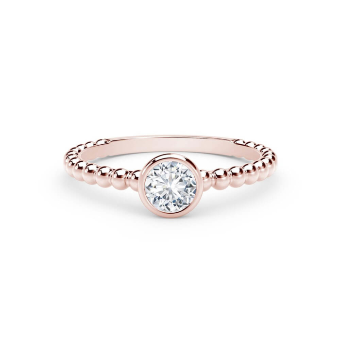 a rose gold ring with a white diamond