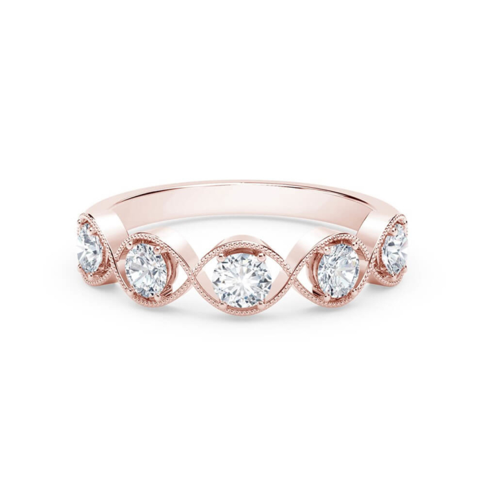 a rose gold ring with three pear shaped diamonds