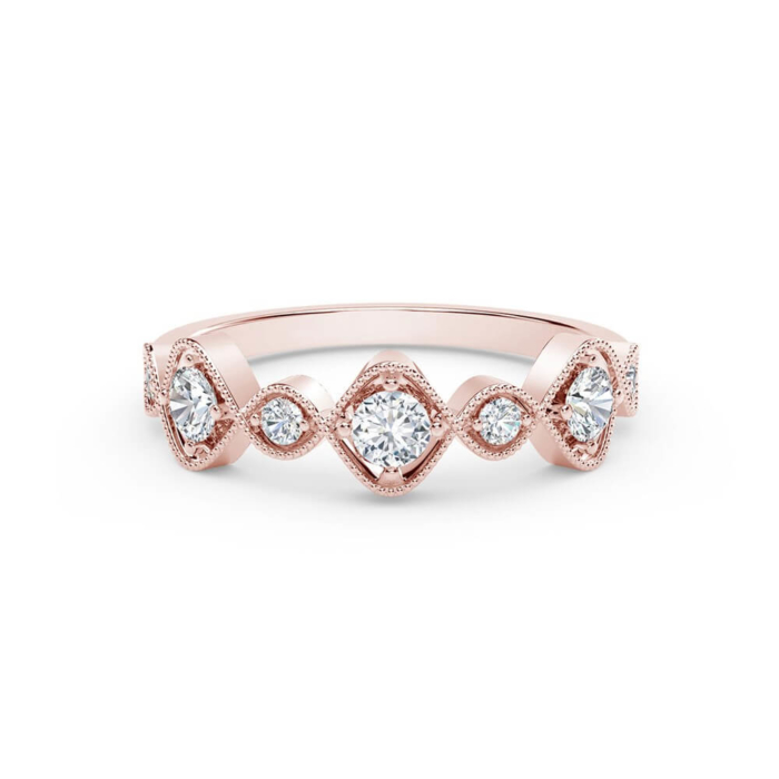 a rose gold ring with three diamonds