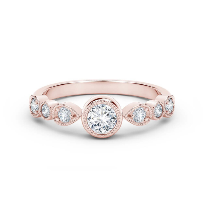 a rose gold engagement ring with three diamonds