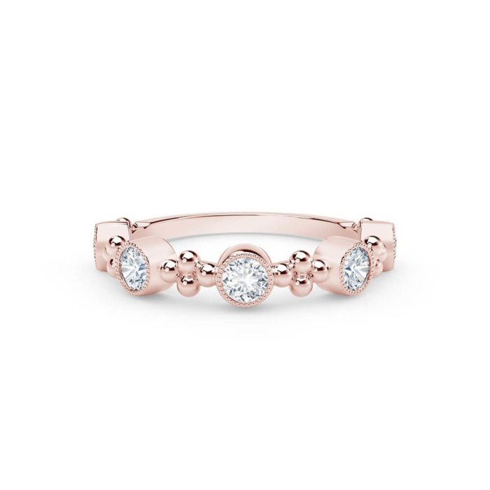 a rose gold ring with three round diamonds