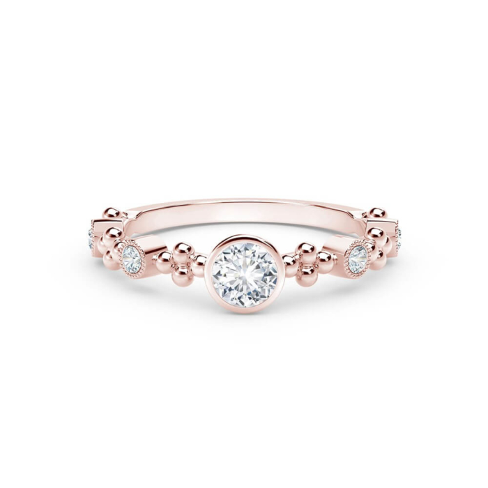 a rose gold ring with a round diamond