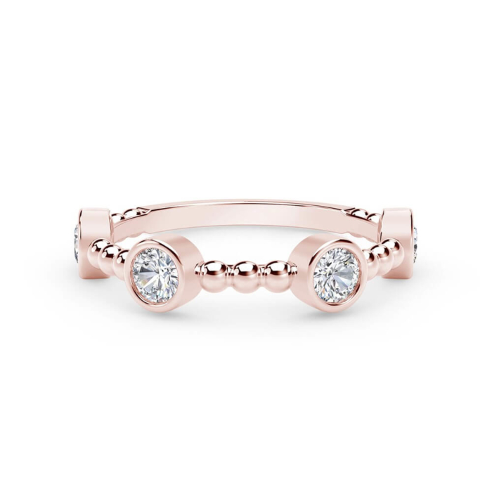 a rose gold ring with two round diamonds