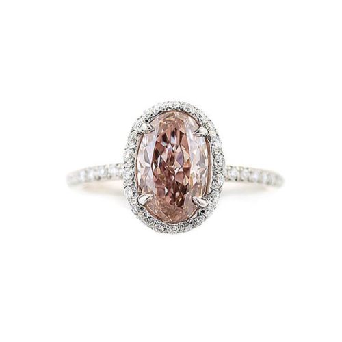 an oval shaped pink diamond ring with diamonds around it