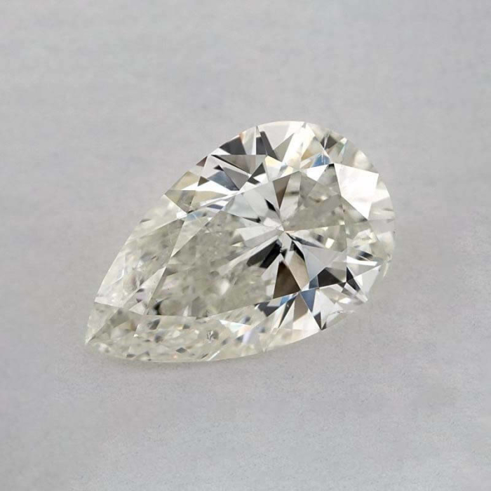 a pear shaped diamond on a white surface