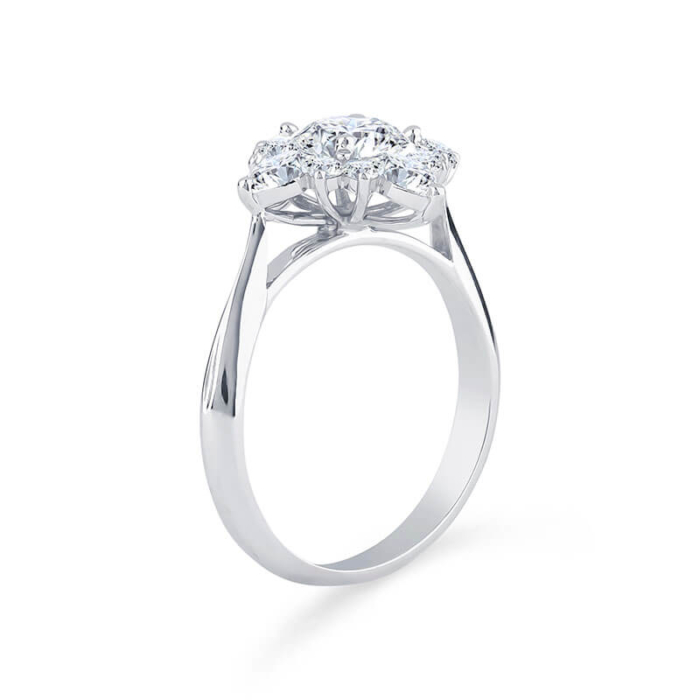 a three stone diamond ring on a white background