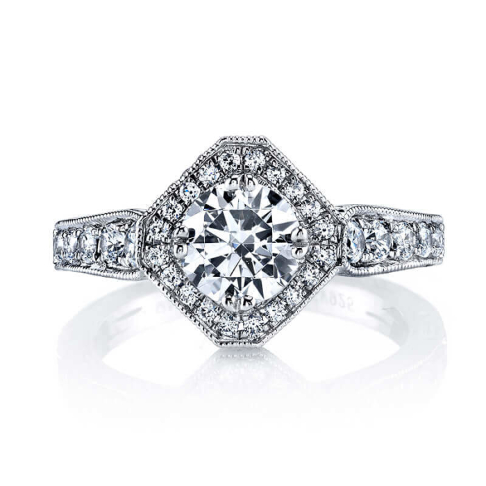 an engagement ring with a diamond center surrounded by diamonds