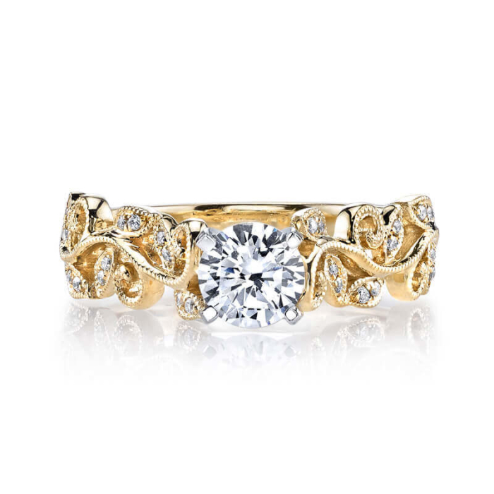 a yellow gold engagement ring with a diamond center