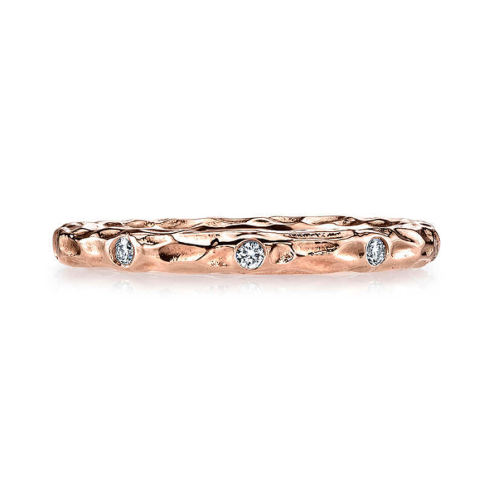 a rose gold wedding band with three diamonds