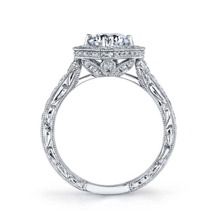a diamond engagement ring with an intricate filigree design