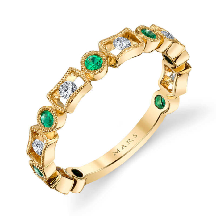 a yellow gold ring with emeralds and diamonds