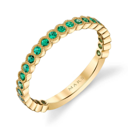 a yellow gold ring with green stones