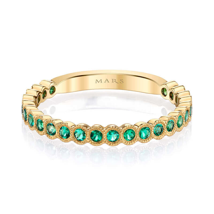 a yellow gold band with green stones