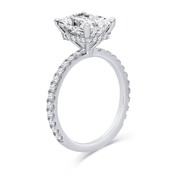 a white gold engagement ring with a round diamond center