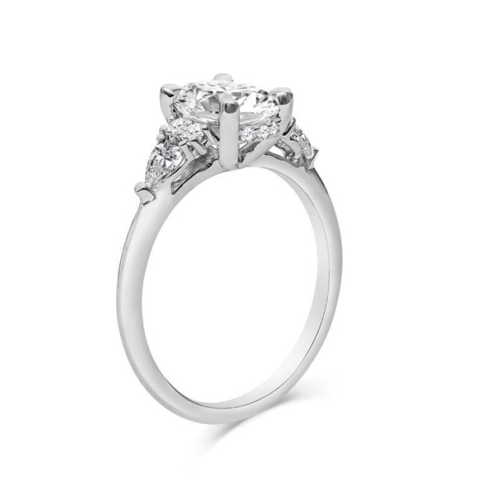 a three stone engagement ring set with diamonds